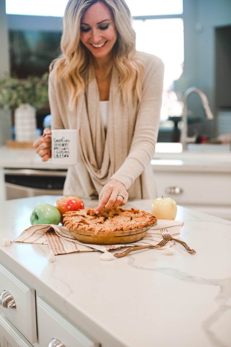 Fall | Thanksgiving | Recipes | Dessert | Mama Mary's Easy Apple Pie Recipe featured by top US lifestyle blog Haute & Humid |Easy Apple Pie Recipe by popular Houston lifestyle blog, Haute and Humid: image of a woman picking at a apple pie.