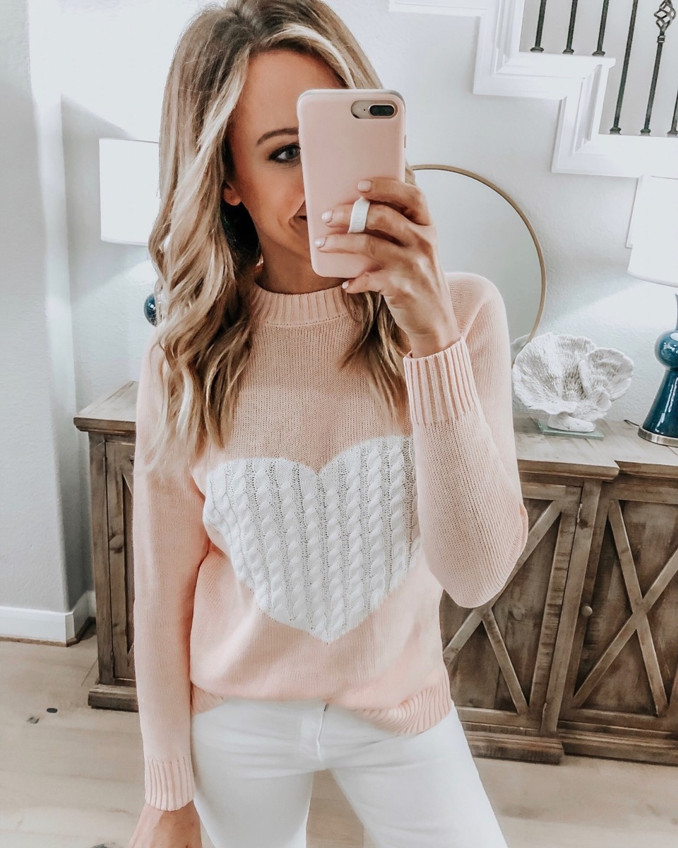 Amazon Favorites featured by top US fashion blog Haute & Humid; Image of a woman wearing a heart sweater from Amazon and Nordstrom white jeans.