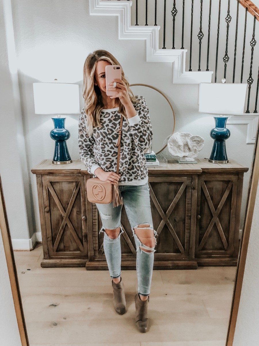 Amazon Favorites featured by top US fashion blog Haute & Humid; Image of a woman wearing Amazon leopard sweatshirt and Madewell jeans.