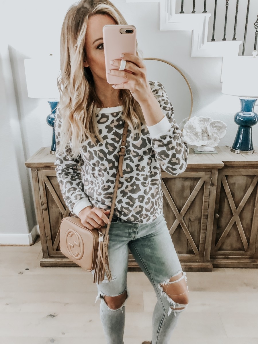 Amazon Favorites featured by top US fashion blog Haute & Humid; Image of a woman wearing Amazon leopard sweatshirt and Madewell jeans.
