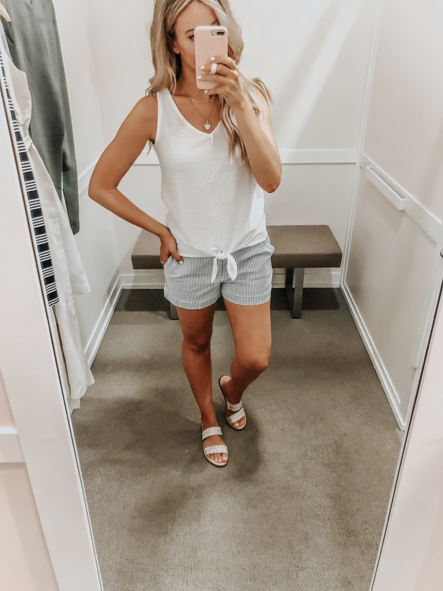 Best Memorial Day Weekend Sales featured by top US fashion blog Haute & Humid; Image of a woman wearing LOFT white tank top and LOFT striped shorts.