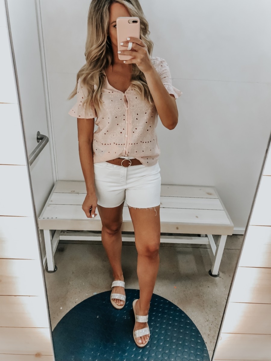 Best Memorial Day Weekend Sales featured by top US fashion blog Haute & Humid; Image of a woman wearing Old Navy white denim shorts and Old Navy eyelet top.