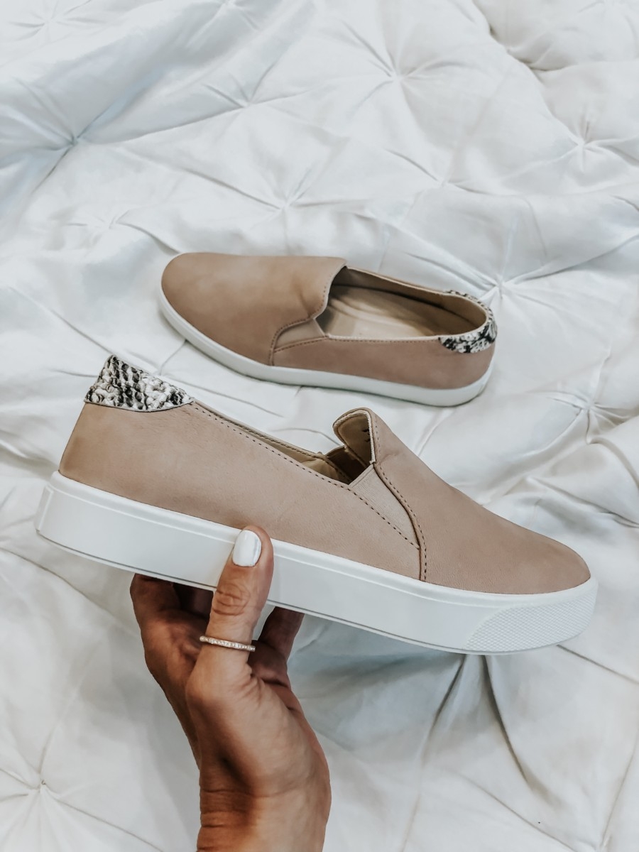 cole haan sneakers | Nordstrom Anniversary Sale Favorites by popular Houston fashion blog, Haute and Humid: image of woman holding COLE HAAN SLIP ON SNEAKERS