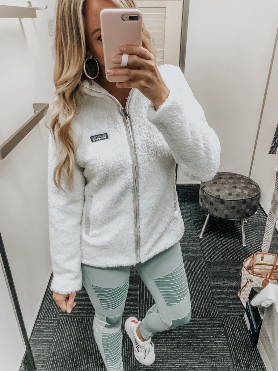 patagonia zip up | Nordstrom Anniversary Sale Favorites by popular Houston fashion blog, Haute and Humid: image of a woman in a dressing room wearing a Los Gatos Fleece Jacket by PATAGONIA, High Waist Moto Leggings by ALO, and white Edge Lux 3 Running Shoe by ADIDAS