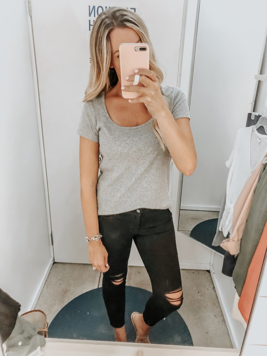 black distressed jeans | Old Navy Try On - August 2019 by popular Florida fashion blog, Haute and Humid: image of a woman standing in a Old Navy dressing room and wearing an Old Navy Slim-Fit Rib-Knit Scoop-Neck Tee and Old Navy High-Waisted Distressed Rockstar Super Skinny Jeans.