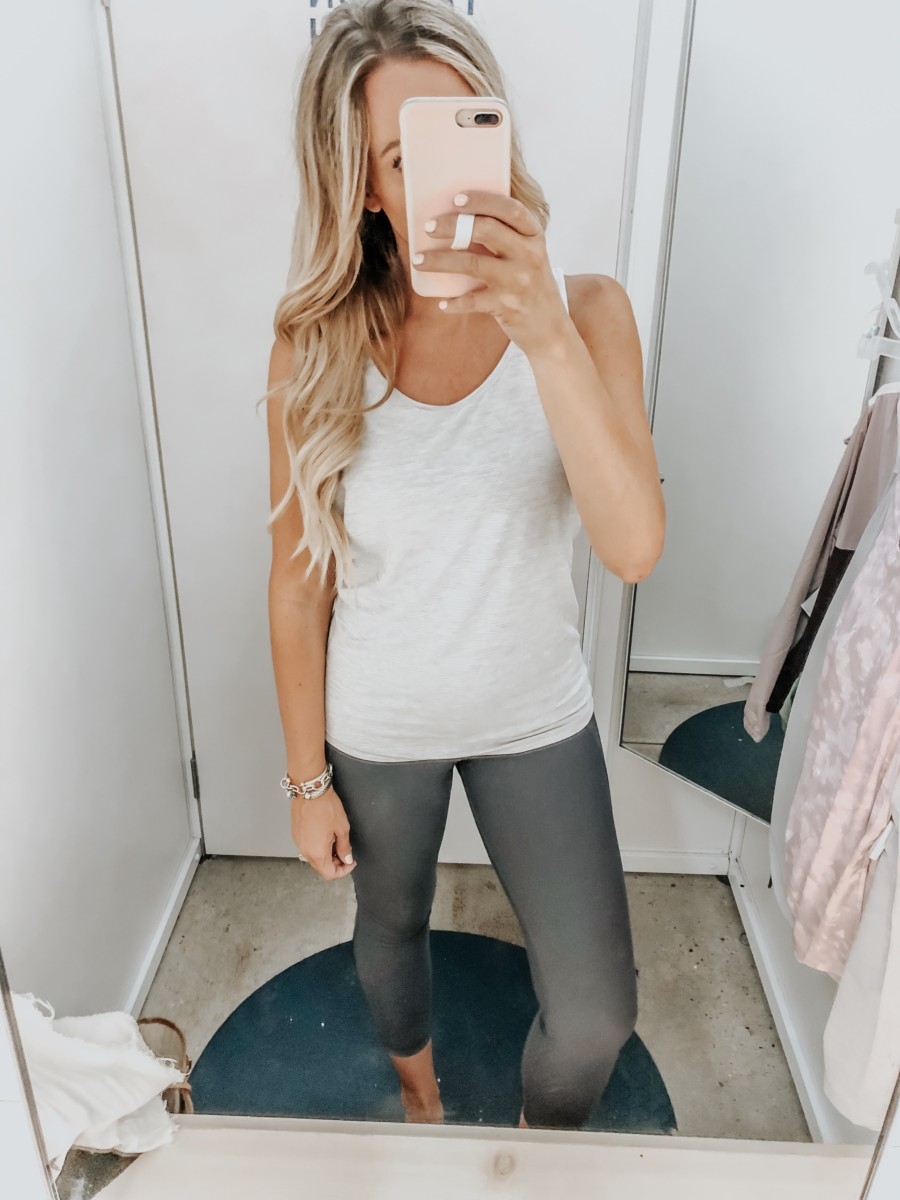 workout leggings | Old Navy Try On - August 2019 by popular Florida fashion blog, Haute and Humid: image of a woman standing in a Old Navy dressing room and wearing an Old Navy Breathe ON Mesh-Back Tank and Old Navy High-Waisted Elevate Built-In Sculpt 7/8-Length Compression Leggings. 