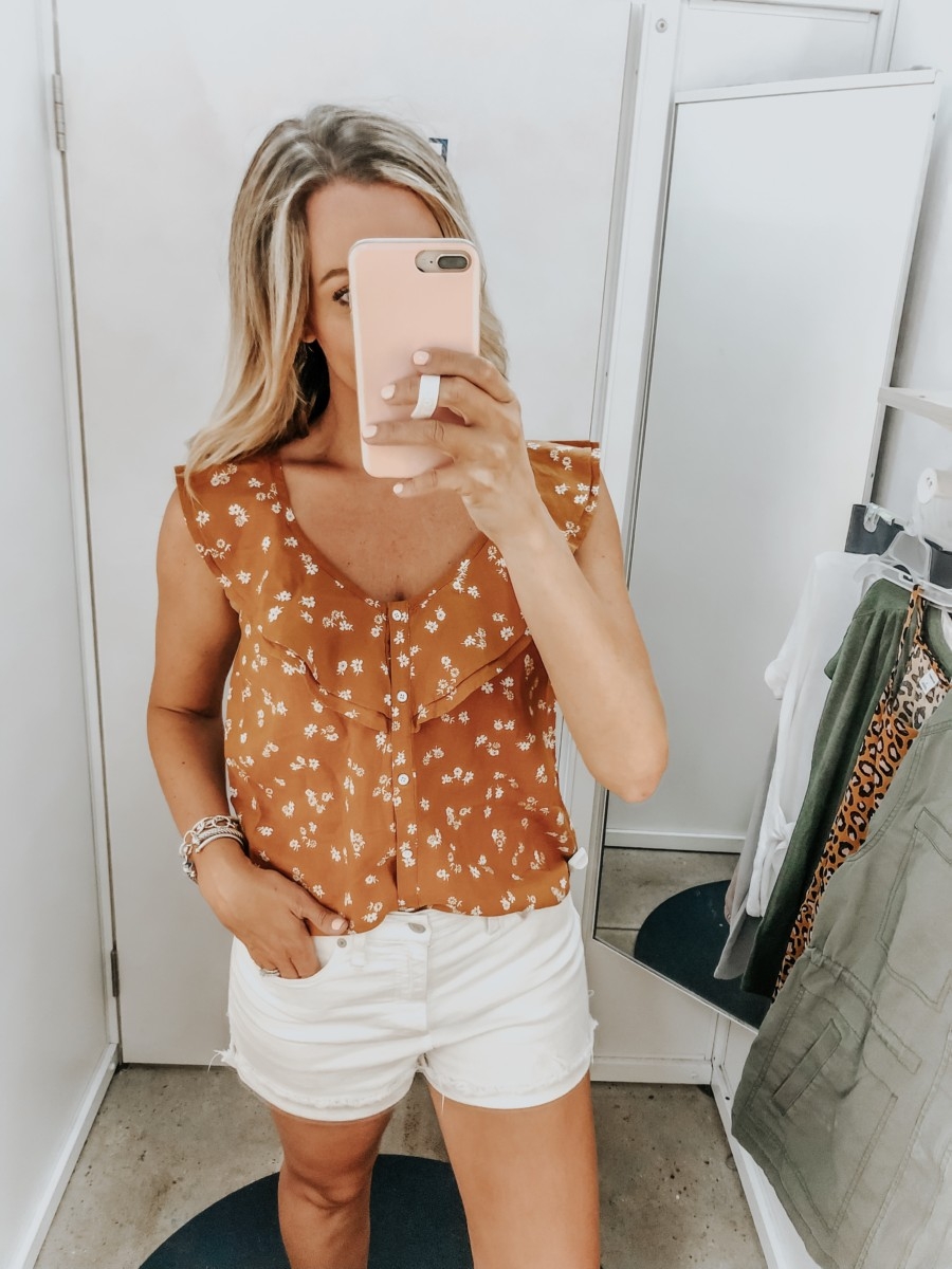 old navy try on | Old Navy Try On - August 2019 by popular Florida fashion blog, Haute and Humid: image of a woman standing in a Old Navy dressing room and wearing an Old Navy Ruffle-Tiered Linen-Blend Button-Front Blouse and Madewell High Waist Denim Shorts. 