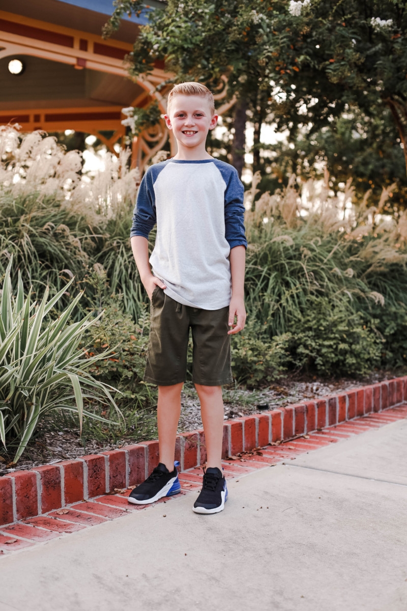 boys back to school clothes | How to Get to School on Time: 7 Easy Ways by popular Houston blog, Haute and Humid: image of a boy standing outside and wearing a Tucker and Tate Baseball T-Shirt, Tucker and Tate Knit Shorts, and Nike Free Run 5.0 Sneaker.