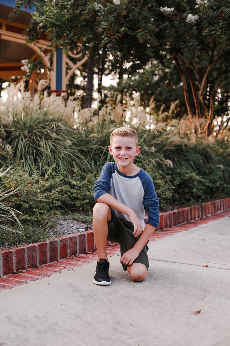 boys fall clothing | How to Get to School on Time: 7 Easy Ways by popular Houston blog, Haute and Humid: image of a boy standing outside and wearing a Tucker and Tate Baseball T-Shirt, Tucker and Tate Knit Shorts, and Nike Free Run 5.0 Sneaker.