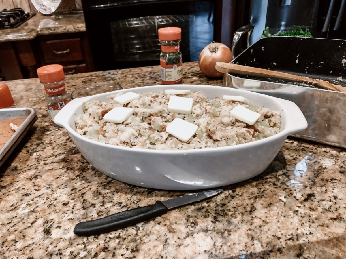 dressing recipe |  Ultimate Homemade Stuffing Recipe with Bread by popular Houston lifestyle blog, Haute and Humid: image of a white ceramic baking dish with uncooked homemade stuffing in it.