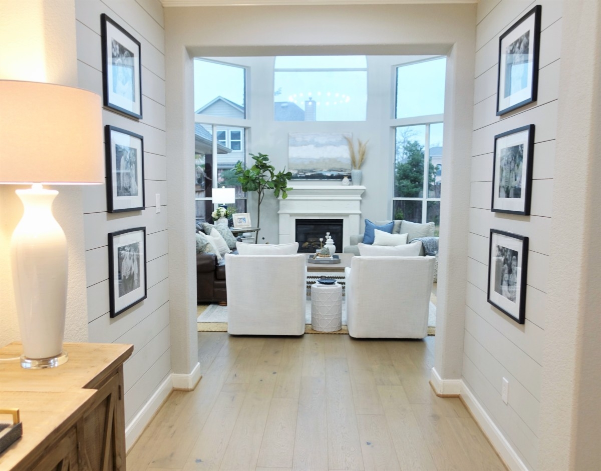 shiplap | Living Room Makeover by popular Houston lifestyle blog, Haute and Humid: image of a remodeled living room with a Wayfair Shayla 20-Light Candle Style Wagon Wheel Chandelier, Wisteria Barley Twist Coffee Table, and Perigold ARIANA VERNAY RECTANGULAR CONSOLE TABLE.