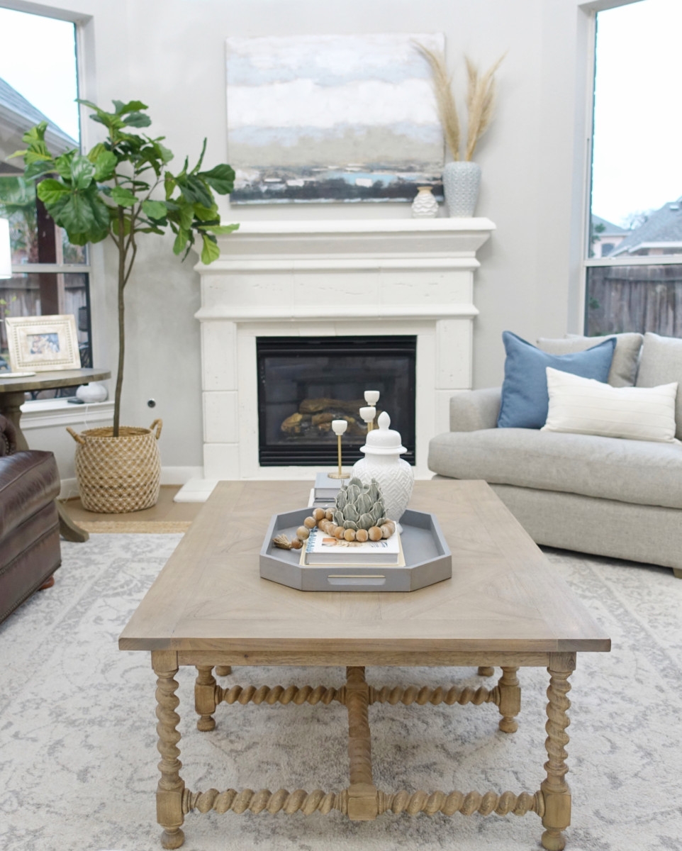 mantle decor | Living Room Makeover by popular Houston lifestyle blog, Haute and Humid: image of a remodeled living room with a Wayfair Shayla 20-Light Candle Style Wagon Wheel Chandelier, Wisteria Barley Twist Coffee Table, and Perigold ARIANA VERNAY RECTANGULAR CONSOLE TABLE.