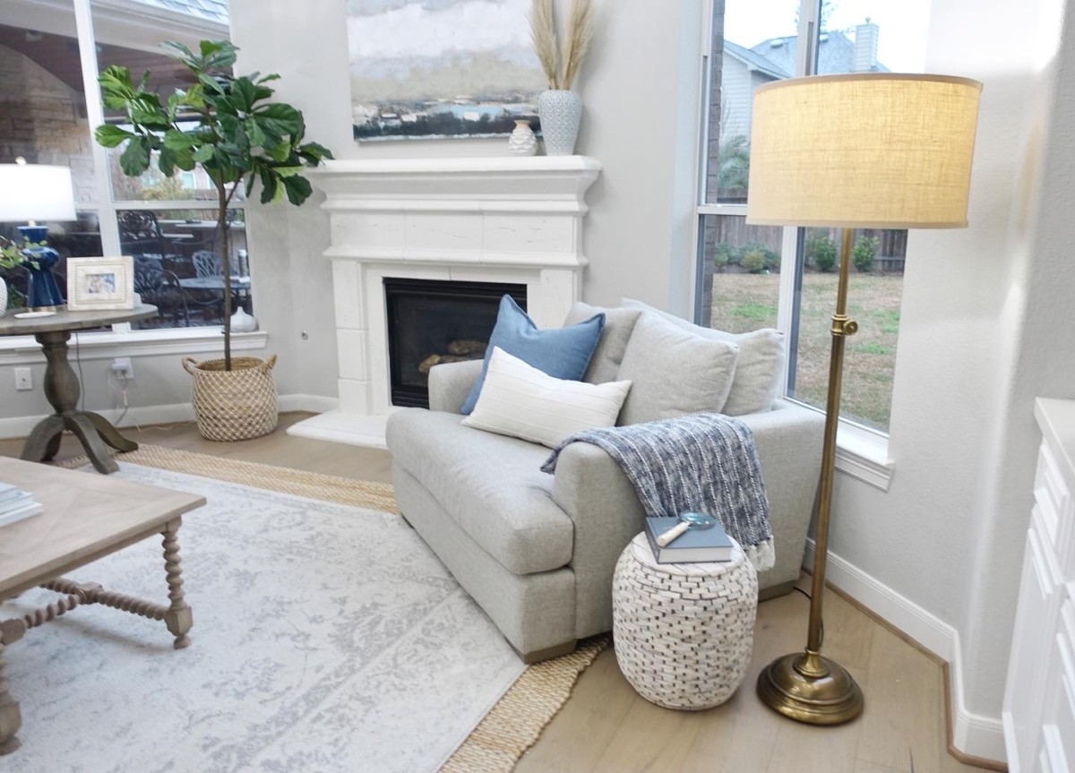 chair and a half | Living Room Makeover by popular Houston lifestyle blog, Haute and Humid: image of a remodeled living room with a Wayfair Shayla 20-Light Candle Style Wagon Wheel Chandelier, Wisteria Barley Twist Coffee Table, and Perigold ARIANA VERNAY RECTANGULAR CONSOLE TABLE.