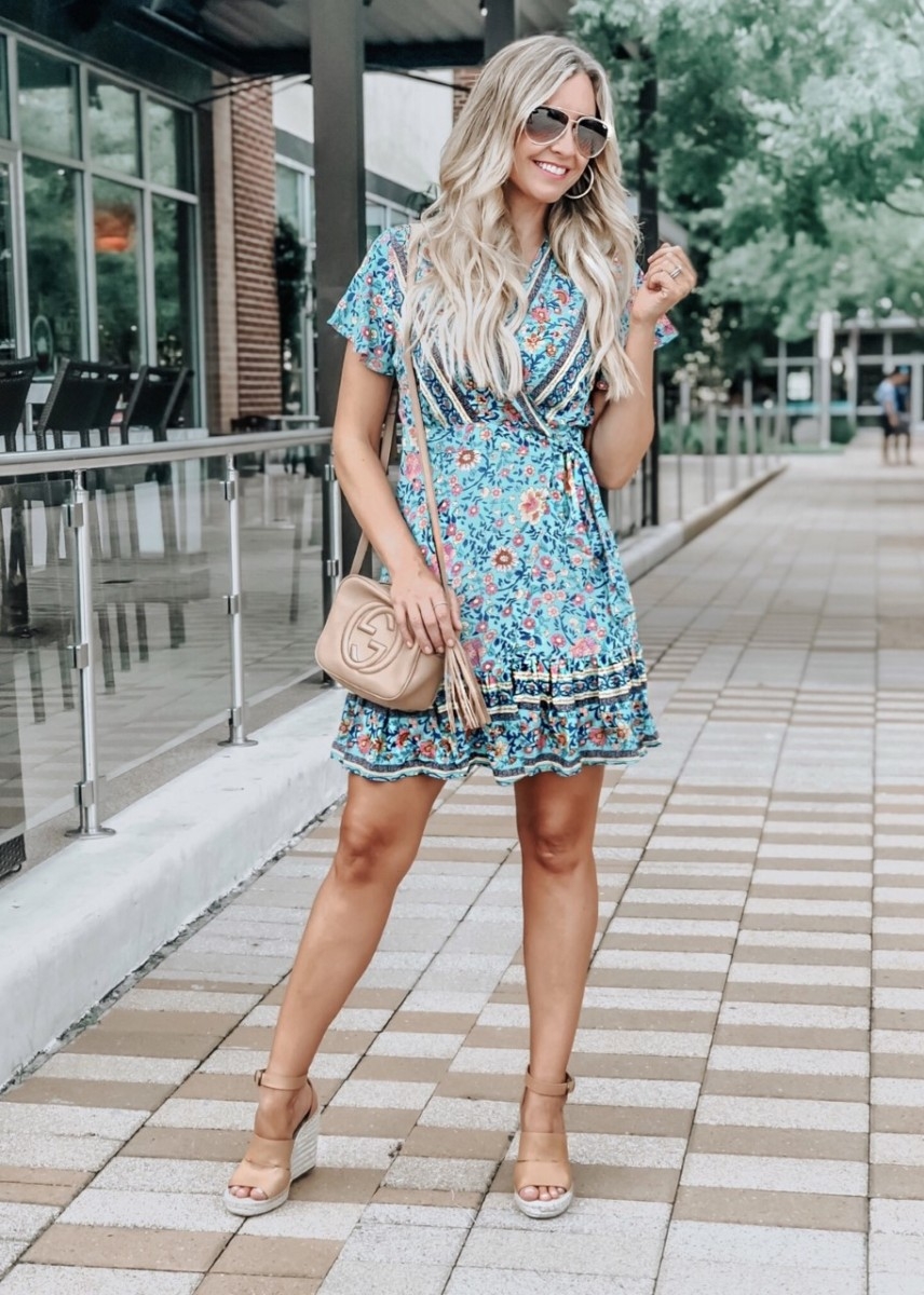 spring dress | Spring Skin Care by popular Houston beauty blog, Haute and Humid: image of a woman standing outside and wearing a Amazon ZESICA Women’s Summer Wrap V Neck Bohemian Floral Print Ruffle Swing A Line Beach Mini Dress, Nordstrom Disco Leather Bag GUCCI, and Nordstrom Poppy Espadrille Wedge Sandal TREASURE & BOND.