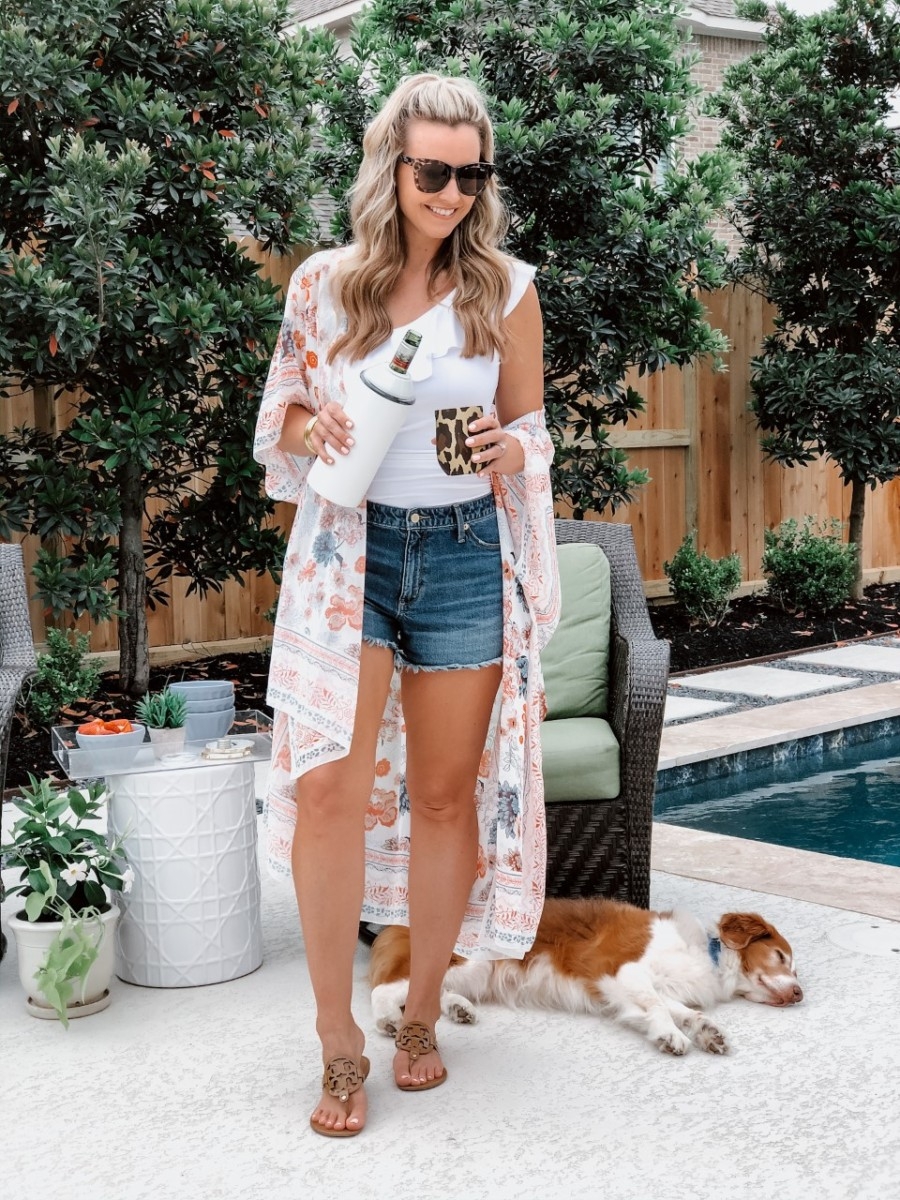 skinny cocktails | Low Calorie Cocktail Recipes by popular Houston lifestyle blog, Haute and Humid: image of a woman standing by her pool and holding a Nordstrom Wine Chiller VINGLACÉ and Nordstrom Corkcicle glass.