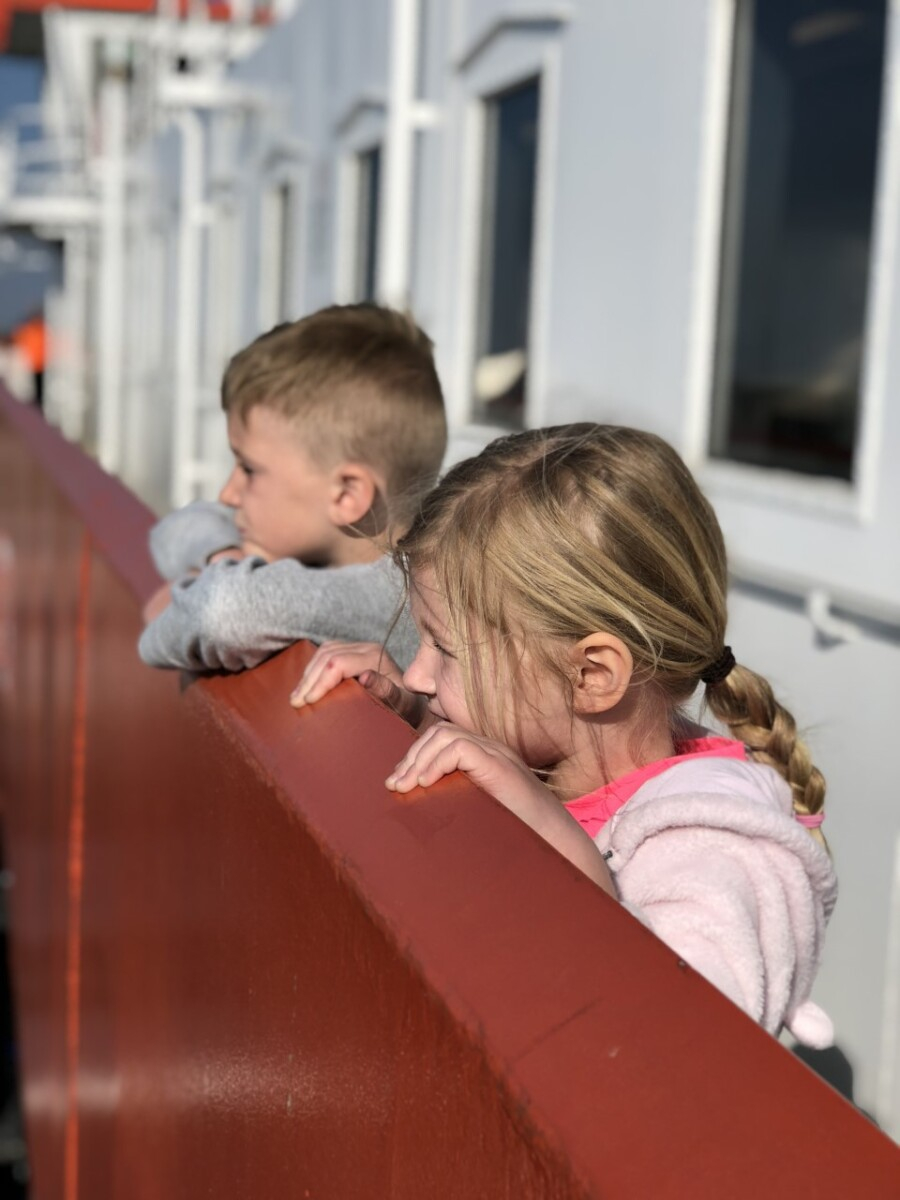 galveston ferry | Galveston Travel Guide by popular Houston travel blog, Haute and Humid: image of two kids riding on the Galveston ferry. 
