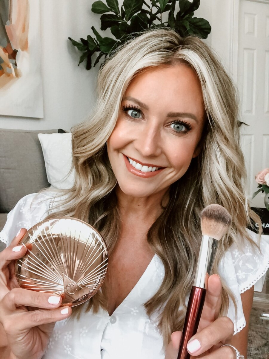 charlotte tilbury bronzer | Sweat Proof Makeup by popular Houston beauty blog, Haute and Humid: image of a woman holding a CHARLOTTE TILBURY Bronzing Powder and makeup brush. 