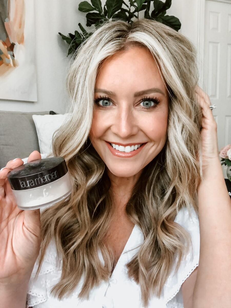 setting powder | Sweat Proof Makeup by popular Houston beauty blog, Haute and Humid: image of a woman holding Laura Mercier Translucent Loose Setting Powder.