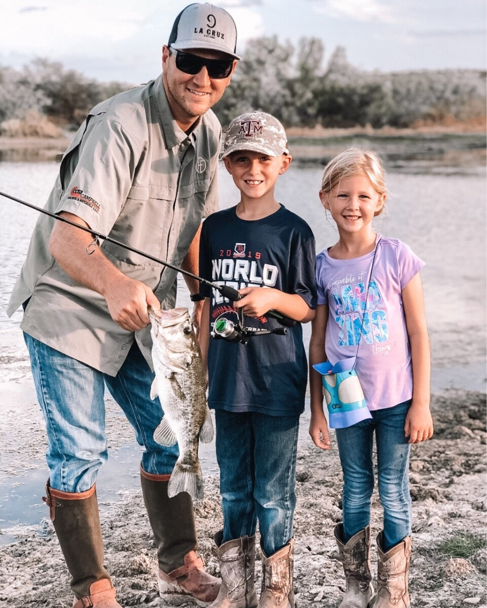 fathers day gifts | Father' Day Gift Ideas by popular Houston lifestyle blog, Haute and Humid: image of a man standing next to his two kids and holding a large fish. 