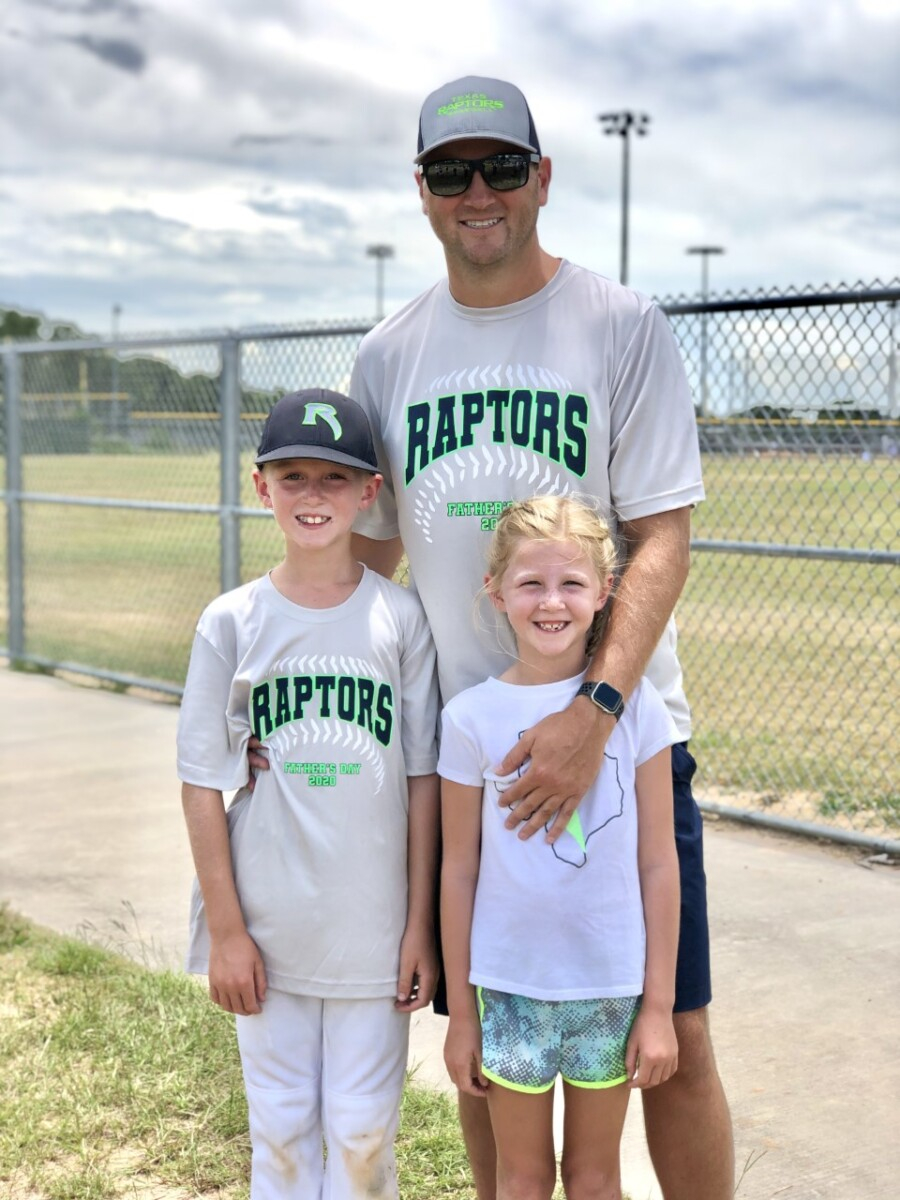 father's day gift guide | Father' Day Gift Ideas by popular Houston lifestyle blog, Haute and Humid: image of a dad standing with his son and daughter on a baseball field and wearing Raptors baseball t-shirts. 