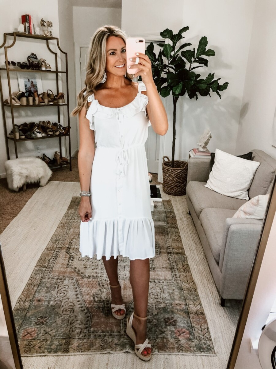 affordable white dress | White Summer Dresses by popular Houston fashion blog, Haute and Humid: image of a woman wearing a Walmart Sofia Vergara Sofia Jeans by Sofia Vergara Flutter Sleeve Midi Dress, Nordstrom BP. Gabby Woven Wedge Sandal, and Amazon LEGITTA Raffia Tassel Rattan Hoop Drop Earrings.