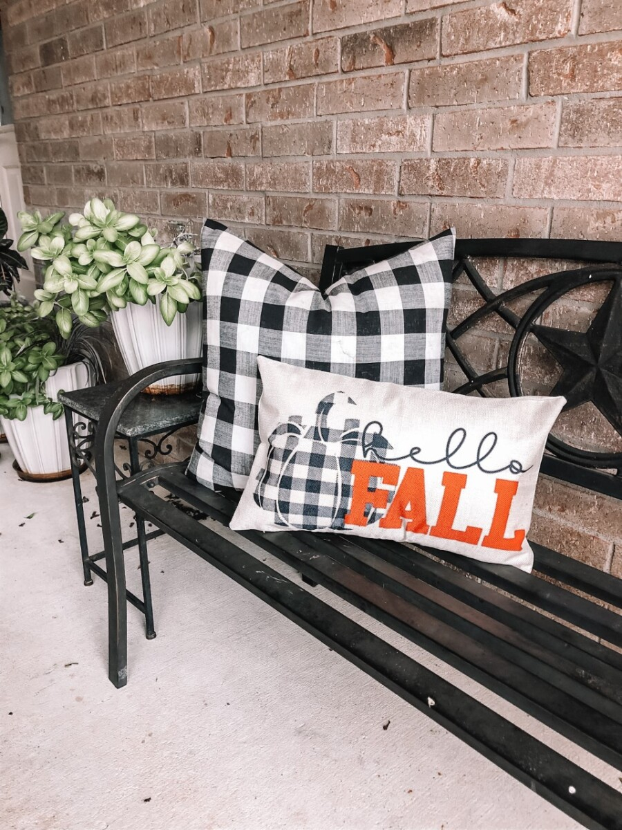 fall pillows | Fall Decor by popular Houston life and style blog, Haute and Humid: image of a black bench with a black and white buffalo check pillow and Hello Fall pillow. 