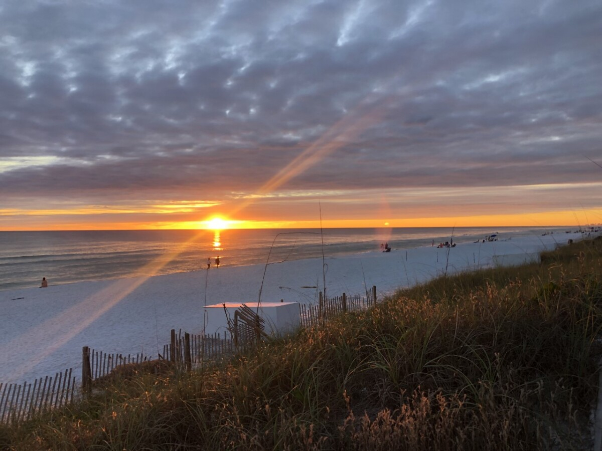 30a beaches  |Florida Beach House Rental by popular Houston travel blog, Haute and Humid: image of a sunset on a white sand beach in Florida. 