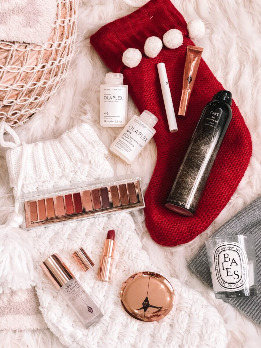 stocking stuffers for her |Stocking Stuffer Ideas by popular Houston life and style blog, Haute and Humid: image of Charlotte Tilbury makeup, Olaplex hair care, and a white and red stocking.