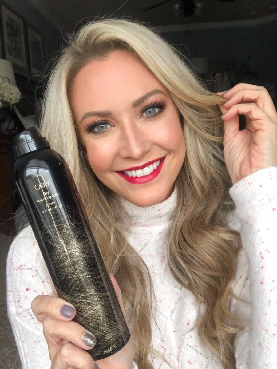 texturizing spray |Stocking Stuffer Ideas by popular Houston life and style blog, Haute and Humid: image of a woman holding a bottle of Oribe texturizing spray. 