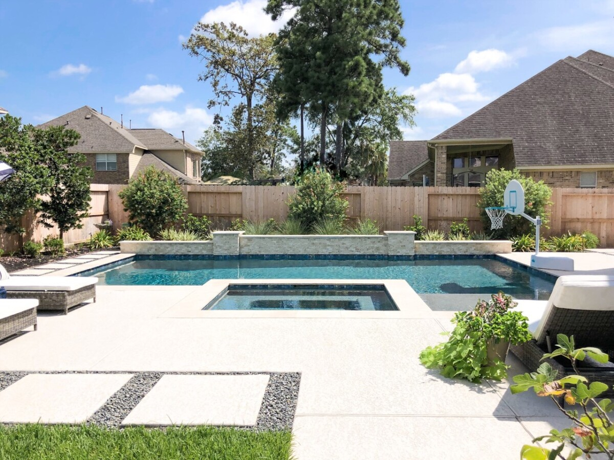 rectangular pool. | pool dig | pool before and after | Outdoor Kitchen by popular Houston life and style blog, Haute and Humid: image of a rectangle pool with a hot tub and basketball hoop. 