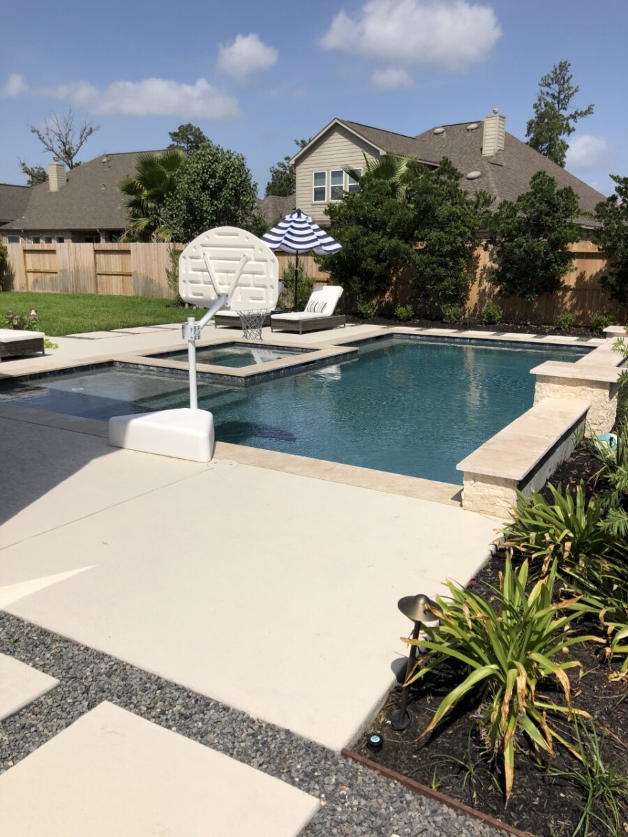 pool design | Outdoor Kitchen by popular Houston life and style blog, Haute and Humid: image of a rectangle pool with a hot tub and basketball hoop. 