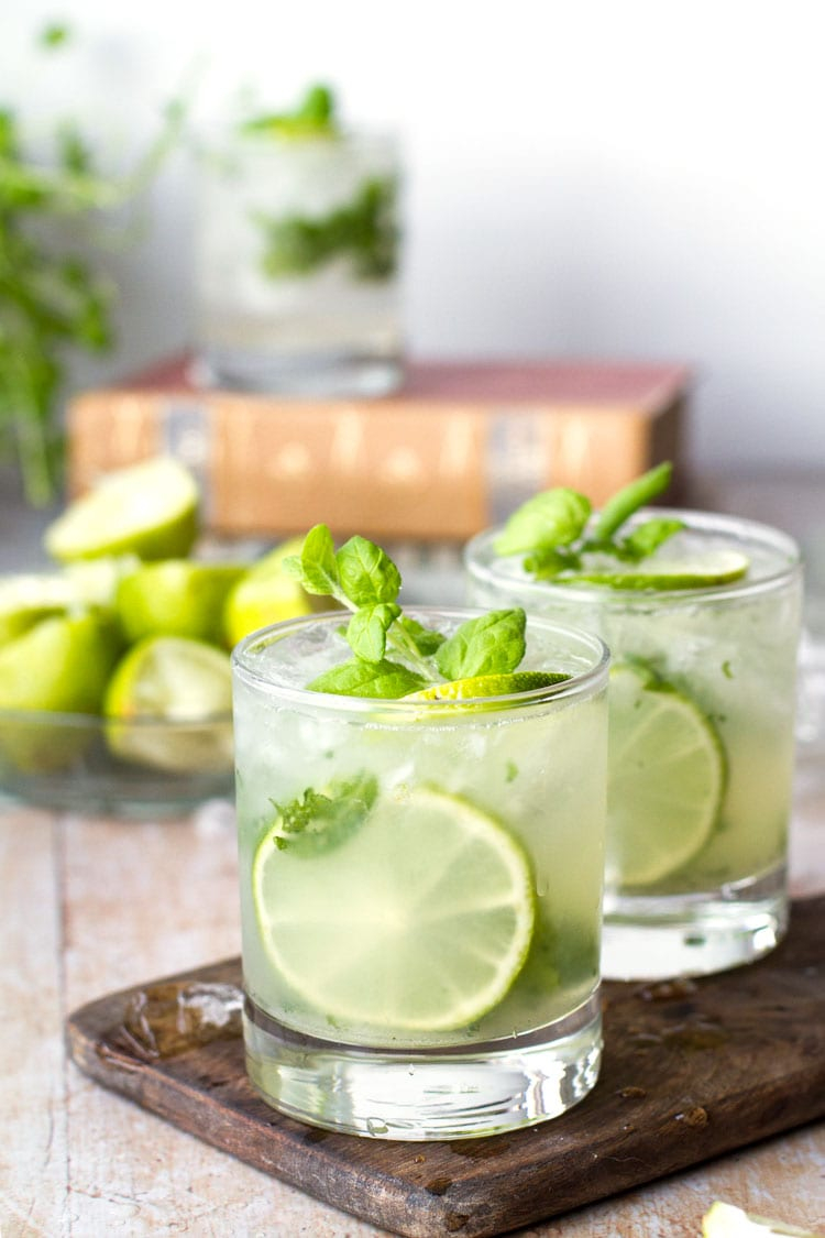 mojito | Pitcher Cocktails by popular Houston lifestyle blog, Haute and Humid: image of mojitos in clear glasses on a wooden serving board. 