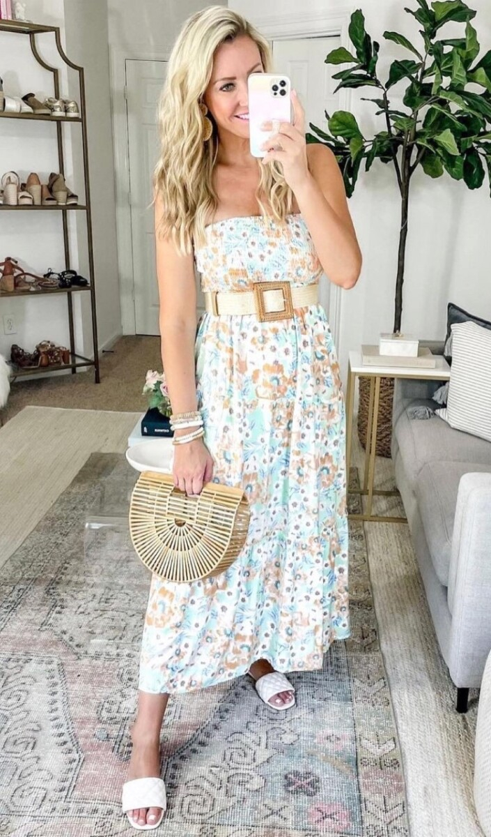 amazon prime maxi dress | Amazon Prime Day by popular Houston fashion blog, Haute and Humid: image of a woman wearing a blue and brown floral print strapless maxi Dres, cream waist belt, white strap slide sandals, and holding a bamboo handbag. 