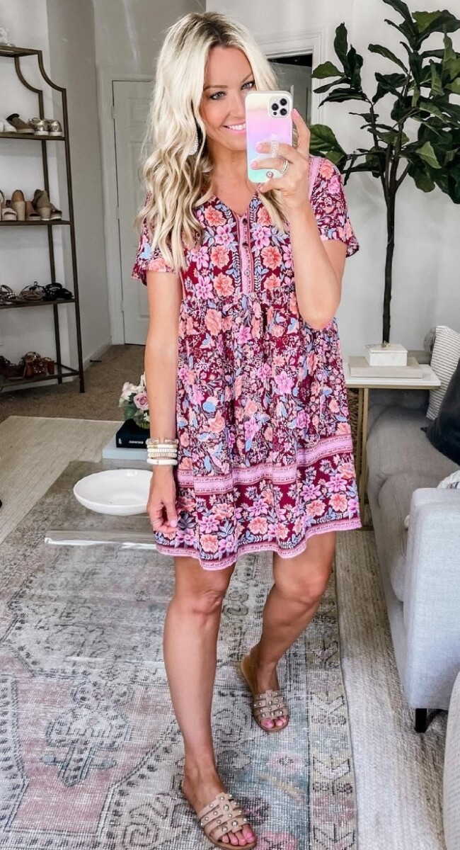 amazon prime dress | Amazon Prime Day by popular Houston fashion blog, Haute and Humid: image of a woman wearing a red and pink floral print mini dress, tan sliver studded slide sandals and white bead bracelets.