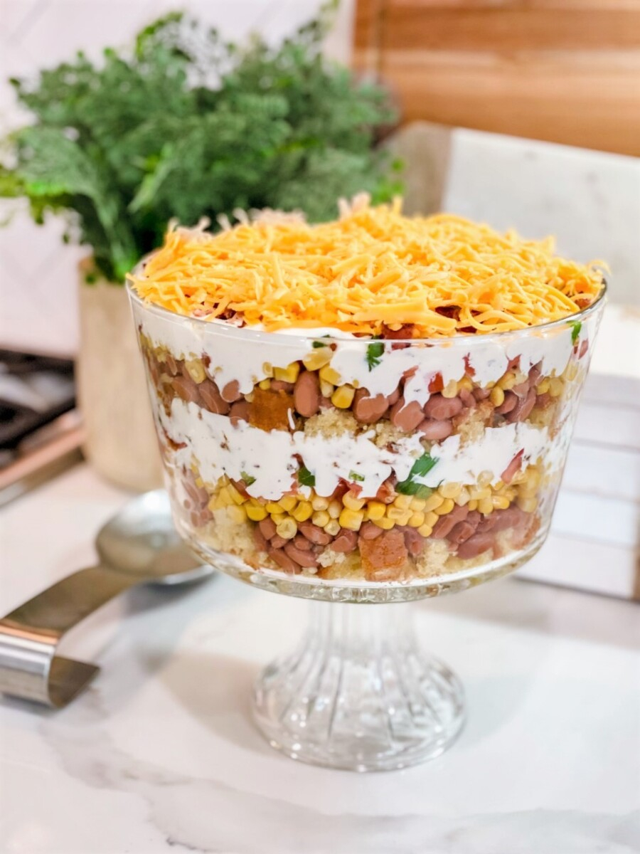 cornbread casserole | Summer Side Dishes by popular Houston lifestyle blog, Haute and Humid: image of a cornbread salad in a clear glass trifle dish.