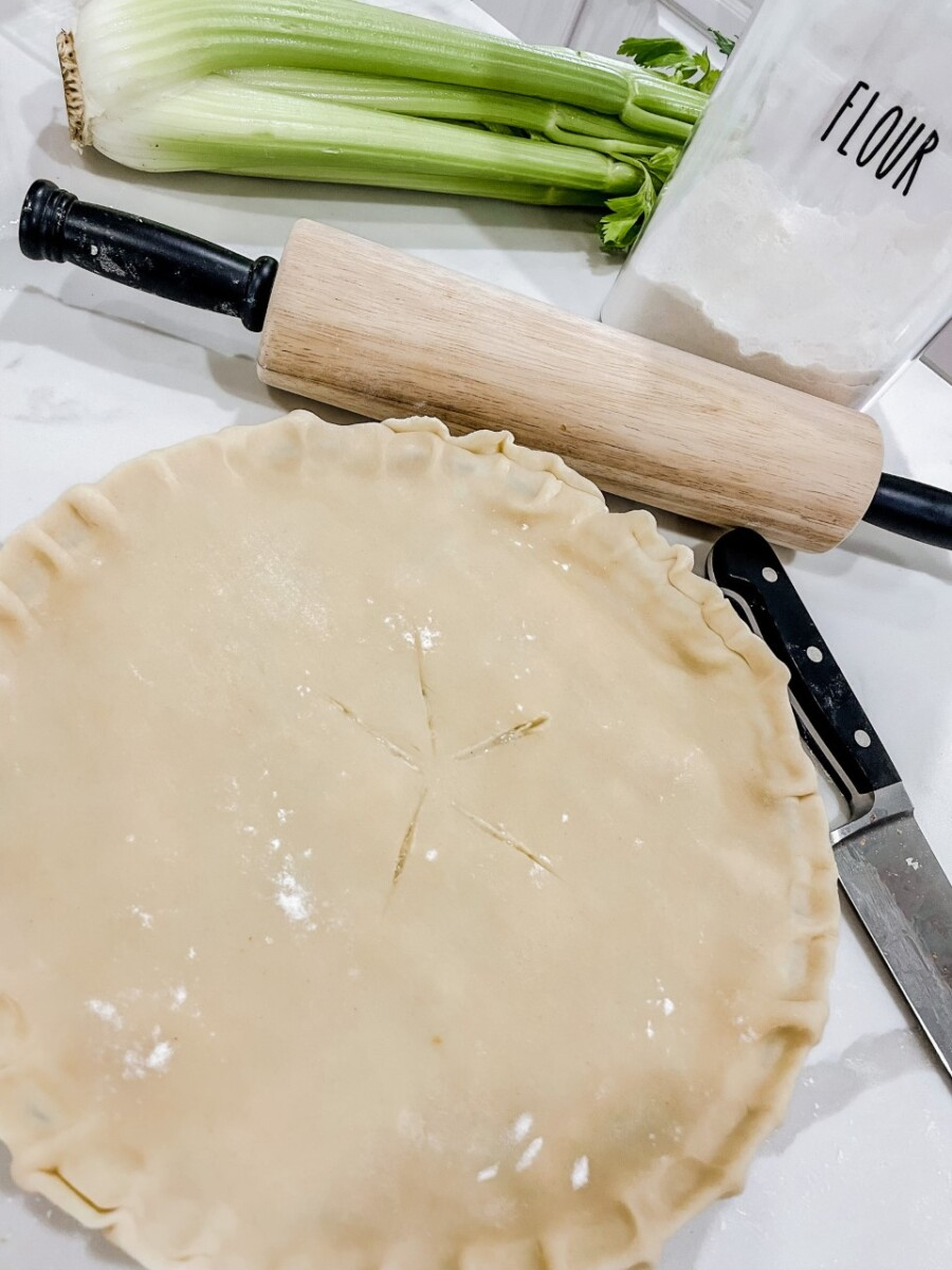 Meal Planning Tips by popular Houston lifestyle blog, Haute and Humid: image of a chicken pot pie next to a wooden rolling pin. 